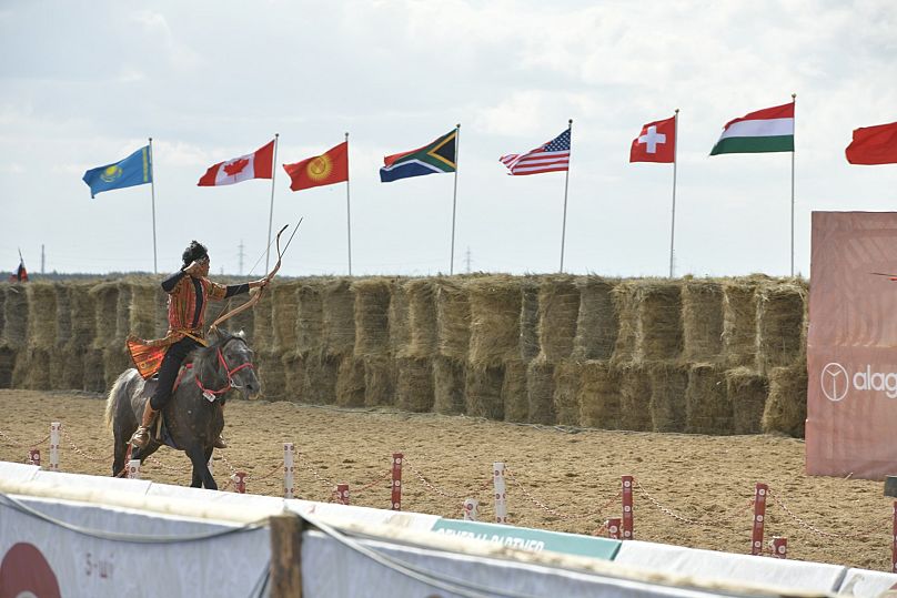 An athlete takes part in the horseback archery competition.