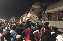 People surround two passenger trains which collided in Egypt's Nile Delta city of Zagazig, September 14, 2024