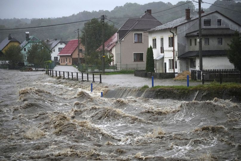 The Bela River flows past homes during floods in Mikulovice, Czech Republic, Saturday, Sept. 14, 2024.