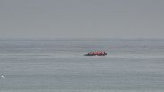 FILE - A boat thought to be with migrants is seen in the sea near the Wimereux beach, France, Wednesday, Sept. 4, 2024