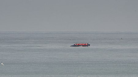 FILE - A boat thought to be with migrants is seen in the sea near the Wimereux beach, France, Wednesday, Sept. 4, 2024