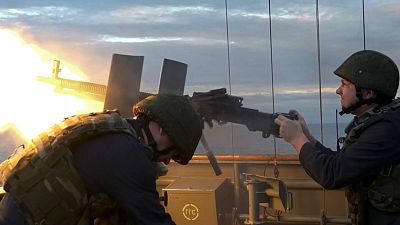 Russian soldiers fire from a Russian warship at sea and air targets during the joint naval and air drills with China, September 12, 2024