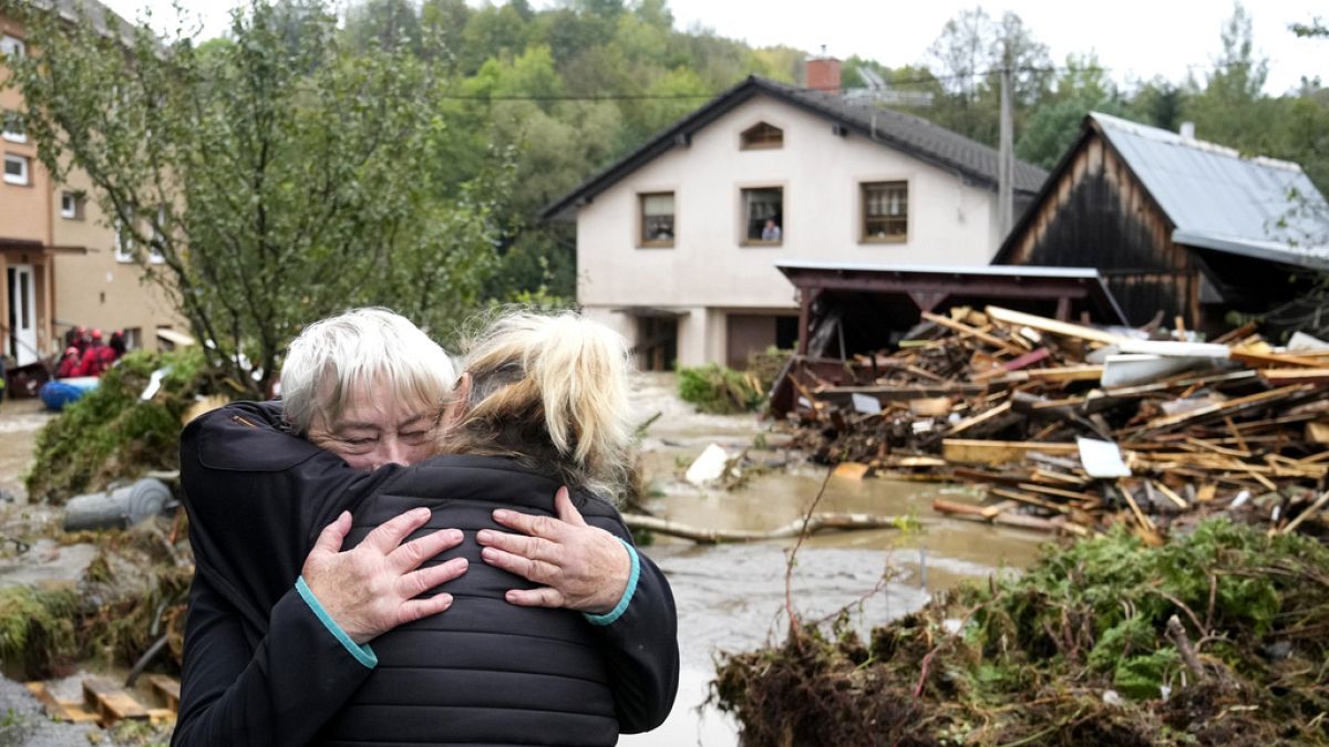 A resident hugs with her relative after being evacuated from her flooded house in Jesenik, Czech Republic, Sunday, Sept. 15, 2024.