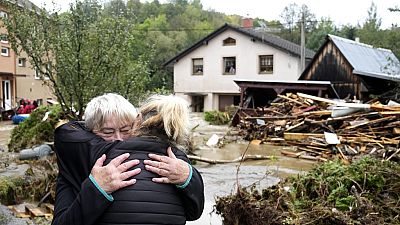 A resident hugs with her relative after being evacuated from her flooded house in Jesenik, Czech Republic, Sunday, Sept. 15, 2024.