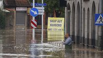 A man stands in waist-deep water that has flooded the streets and houses in the town of Kłodzko, in Poland's southwest, Sunday, Sept. 15, 2024