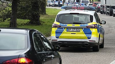 German police escort a French car to a control near the border to Belgium, in Aachen