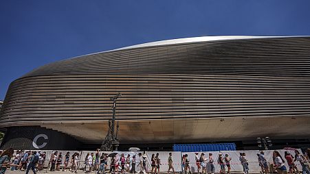 Fans queue for Taylor Swift's concert outside Madrid's Santiago Bernabeu stadium in May 2024