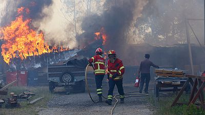 Firefighters work to control a fire in Sever do Vouga, a town in northern Portugal that has been surrounded by forest fires, Monday, Sept. 16, 2024. 