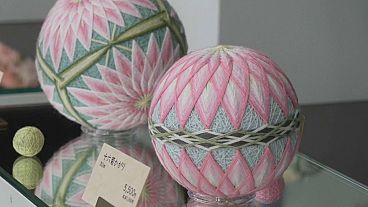 Two completed Sanuki Kagari Temari balls are on display in Eiko Araki's studio in Kawaramachi, Kagawa prefecture, Japan.