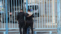 A member of the Moroccan security forces detains a man attempting to cross the border with the Spanish enclave of Ceuta, in Fnideq, Morocco, Monday, Sept. 16, 2024.