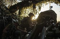 Ukrainian servicemen of 148th separate artillery brigade of the Air Assault Forces prepare their M777 howitzer before firing towards Russian positions at the frontline in Done