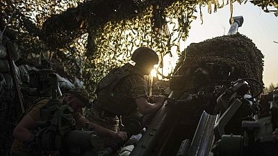 Ukrainian servicemen of 148th separate artillery brigade of the Air Assault Forces prepare their M777 howitzer before firing towards Russian positions at the frontline in Done