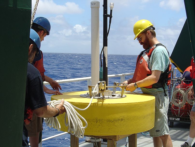 Marine chemist Ken Buesseler works on a “clap - trap” mooring during the Vertical Transport In the Global Ocean (VERTIGO) pro ject in 2004.