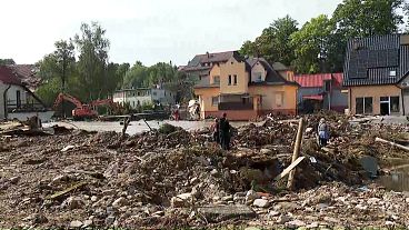 People looking at the damage left behind by the floods.