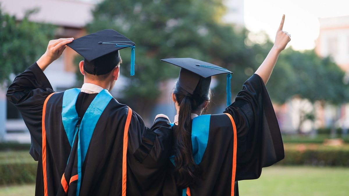 Two university graduates at a graduation ceremony