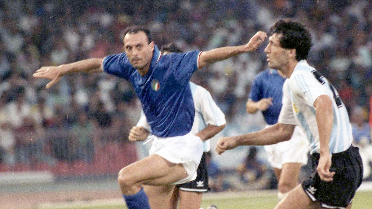 Italy's Salvatore Schillaci, left, and Argentina's Juan Simon chase the ball during the World Cup semi-final, in Naples, 3 July 1990