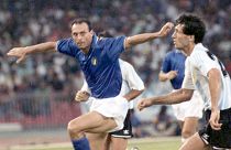 Italy's Salvatore Schillaci, left, and Argentina's Juan Simon chase the ball during the World Cup semi-final, in Naples, 3 July 1990