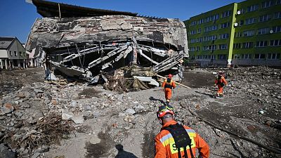 Firefighters inspecting safety of houses following heavy flooding in the town of Stronie Slaskie, southwestern Poland.