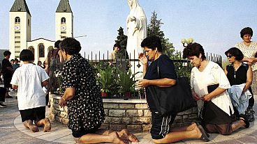 Roman Catholic women pray on  feast of the Assumption in Medjugorje, some 120 kilometers (75 miles) south of the Bosnian capital, Sarajevo, on Aug. 15 2000