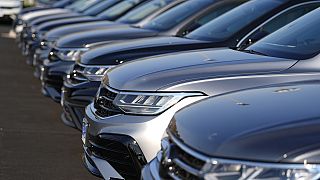 A long row of unsold 2024 Tiguan utility vehicles are shown Sunday, July 28, 2024, at a Volkswagen dealership in Denver. 