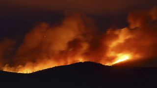 Clouds of smoke drift with the strong wind as fires rage on the hills around Sever do Vouga, a town in northern Portugal that has been surrounded by forest fires, Sept. 2024.