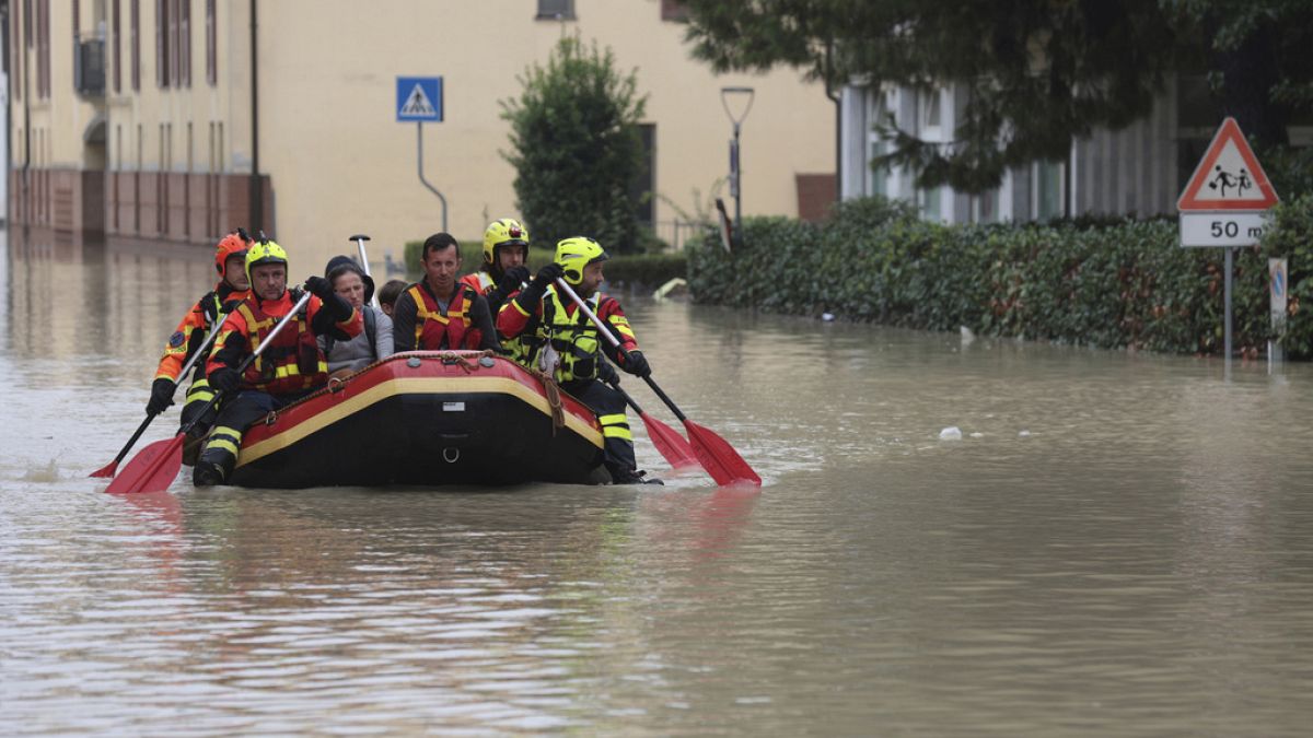 Firefighters use a dingy boat to evacuate civilians after flooding in Faenza, in the region of Emilia Romagna, Italy, Thursday, Sept. 19, 2024