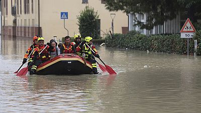 Firefighters use a dingy boat to evacuate civilians after flooding in Faenza, in the region of Emilia Romagna, Italy, Thursday, Sept. 19, 2024