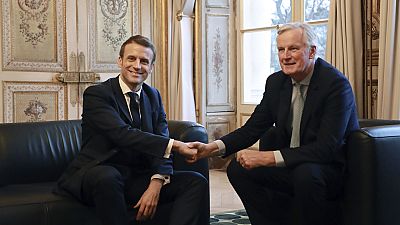 Emmanuel Macron, left, shakes hands with then-European Union chief Brexit negotiator Michel Barnier at the Elysee Palace in Paris, Friday, Jan. 31, 2020.