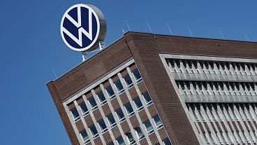 The Volkswagen logo stand on the top of a VW headquarters building in Wolfsburg, Germany