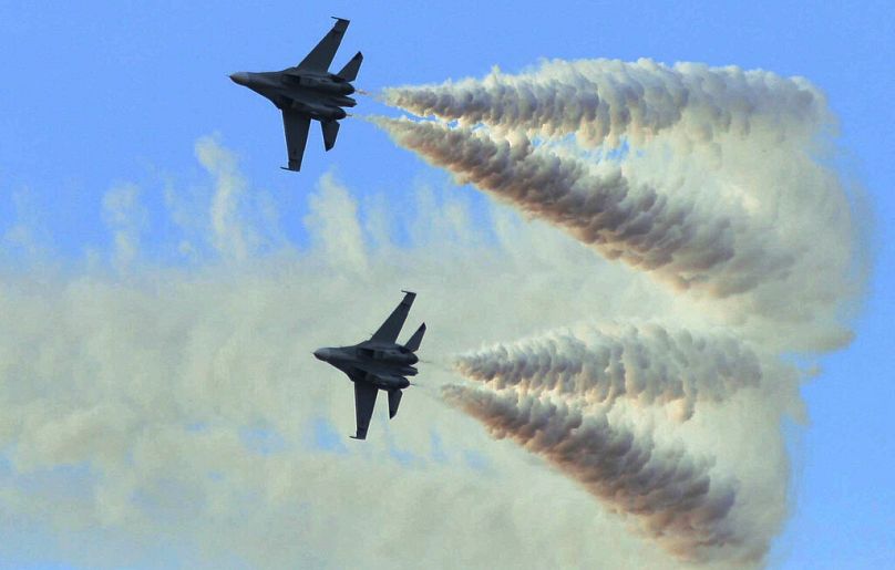 Venezuela's two Sukhoi fighter jets fly at the anniversary celebration of Venezuela's Air Force in Maracay, Venezuel