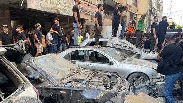 People gather at the scene of an Israeli missile strike in the southern suburbs of Beirut.