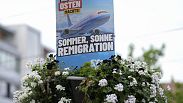 An election campaign poster of the far-right Alternative for Germany, AfD, promising "summer, sun, remigration" and depicting a plane with the logo "Deportation-Hansa." is dis