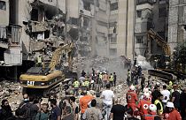 Emergency workers use excavators to clear the rubble at the site of Friday's Israeli strike in Beirut's southern suburbs, Saturday, Sept. 21, 2024. 