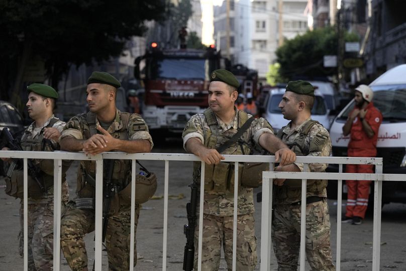 Lebanese soldiers secure the area a day after an Israeli missile strike in Beirut's southern suburbs, Saturday, Sept. 21, 2024.