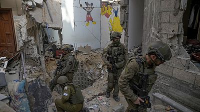 Israeli soldiers stand at the entrance of a tunnel where the military says six Israeli hostages were recently killed by Hamas militants, in the southern Gaza Strip on Sep 13.