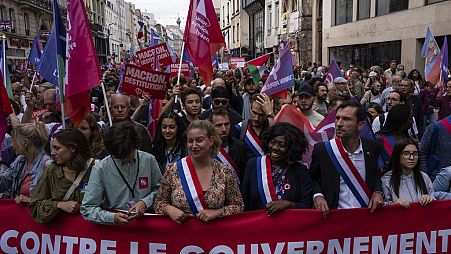 Demonstrators take part in a protest against the new French Prime Minister Michel Barnier and the government, in Paris, France, Saturday, Sept. 21, 2024. (AP Photo/Louise Delm