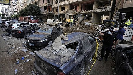 Damaged cars at the site of Friday's Israeli strike in Beirut's southern suburbs, Saturday, Sept. 21, 2024.