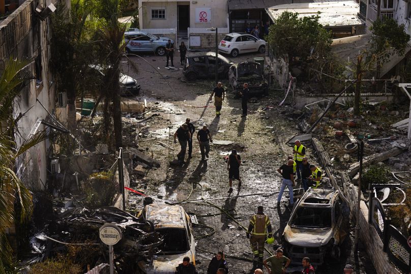 Israeli security forces examine the site hit by a rocket fired from Lebanon, in Kiryat Bialik, northern Israel, on Sunday, Sept. 22, 2024