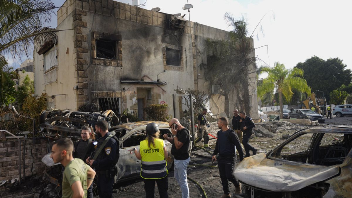 sraeli security forces examine the site hit by a rocket fired from Lebanon, in Kiryat Bialik, northern Israel, on Sunday, Sept. 22, 2024