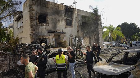 sraeli security forces examine the site hit by a rocket fired from Lebanon, in Kiryat Bialik, northern Israel, on Sunday, Sept. 22, 2024