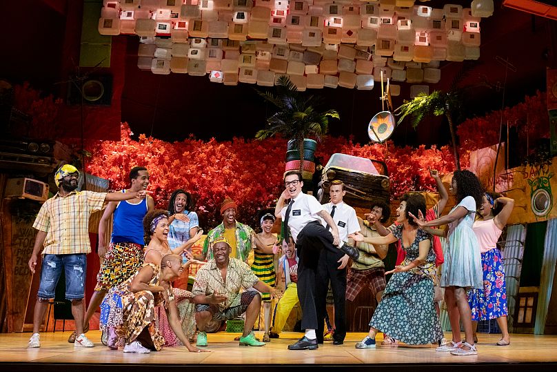 A chorus line gathers in a scene from 'Book of Mormon'