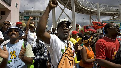 In this Feb. 23, 2009 file photo, labor union members shout slogans during a protest in Point-a-Pitre, French Caribbean island of Guadeloupe.