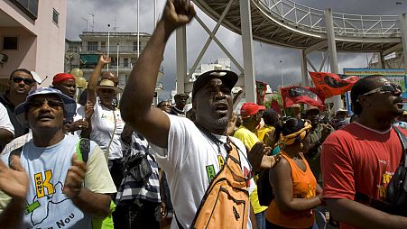 In this Feb. 23, 2009 file photo, labor union members shout slogans during a protest in Point-a-Pitre, French Caribbean island of Guadeloupe.