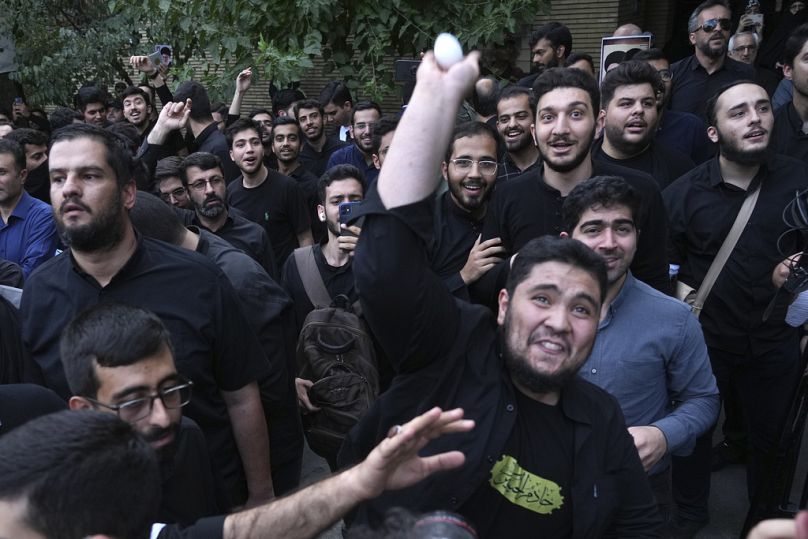  demonstrator throws an egg at the Swedish Embassy in Tehran during a protest over the desecration of the Quran, July 2023.