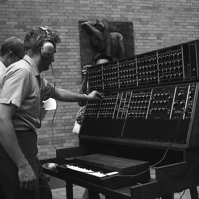 Robert Moog, 35, makes final adjustment on the Moog Synthesizer prior to a jazz concert at Museum of Modern Art, 1969