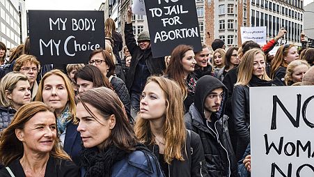 Polish women protest against a legislative proposal for a total ban on abortion in Poland, during a demonstration near EU headquarters in Brussels, Monday, Oct. 3, 2016.