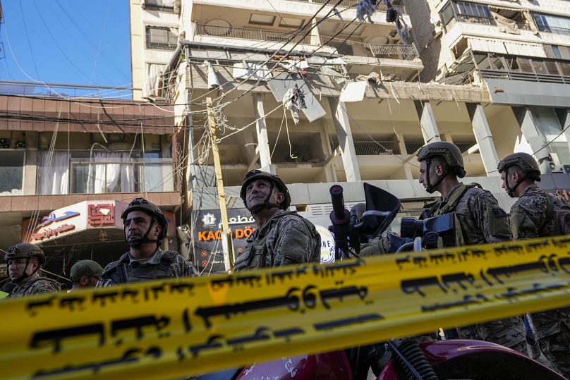 Lebanese soldiers cordon off the area at the site of an Israeli airstrike in Beirut's southern suburbs, September 26, 2024