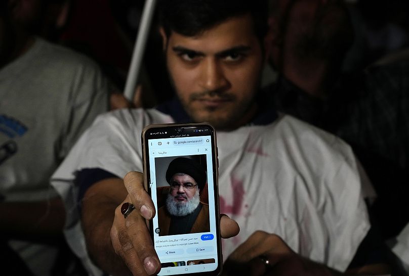 Un manifestant iranien montre un portrait du chef du Hezbollah Hassan Nasrallah sur son téléphone lors d'une manifestation de soutien au Hezbollah à Téhéran, le 28 septembre.