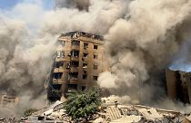 Smoke rises as a building collapses in Beirut's southern suburbs