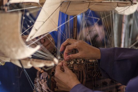 Malagasy women build a model ship at the Le Village model ship making company in Antananarivo, Madagascar, Wednesday, Sept. 11, 2024.